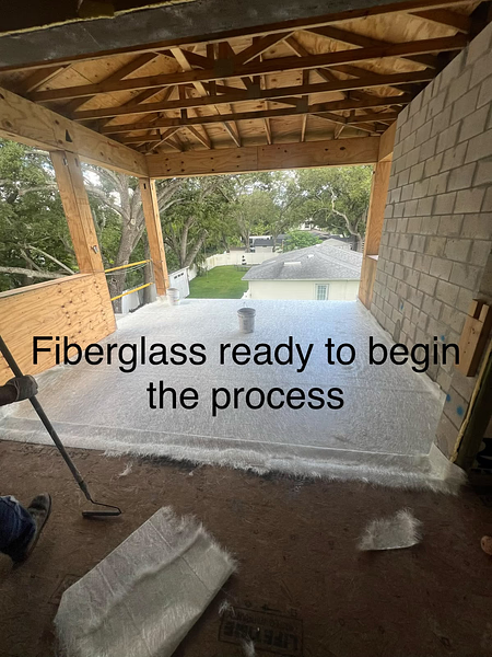 Fiberglass mat laid over a framed balcony deck before resin and finishing