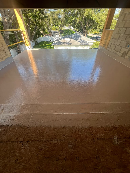 Partially coated balcony deck showing the fiberglass repair and refinishing process